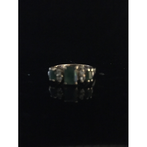 24 - An emerald and diamond half hoop ring, the three coloured stones of emerald cut interspersed with tw... 