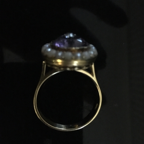 27 - An amethyst, diamond and seed pearl ring, the oval mixed cut amethyst of 14.8 x 12mm set to the cent... 