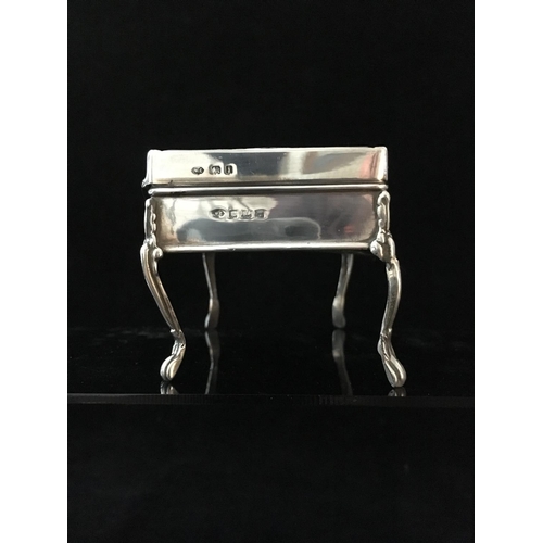 39 - A stained horn and silver pique work box in the form of a writing table, the upper surface decorated... 