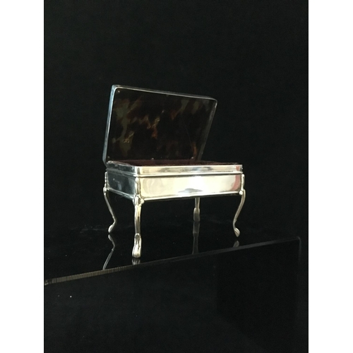 39 - A stained horn and silver pique work box in the form of a writing table, the upper surface decorated... 