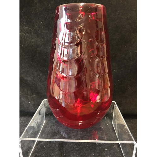 148 - A large Mid Century ruby glass vase, in the manner of Marriot Powell, Whitefriars, moulded with fest... 