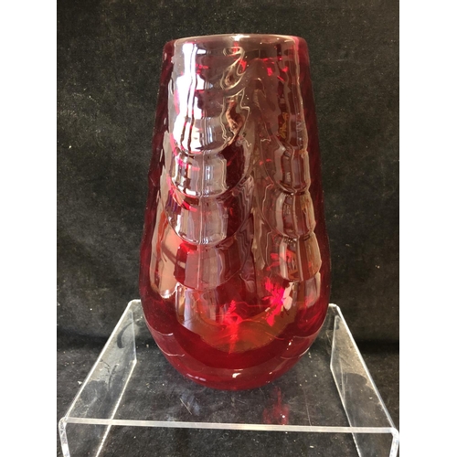 148 - A large Mid Century ruby glass vase, in the manner of Marriot Powell, Whitefriars, moulded with fest... 