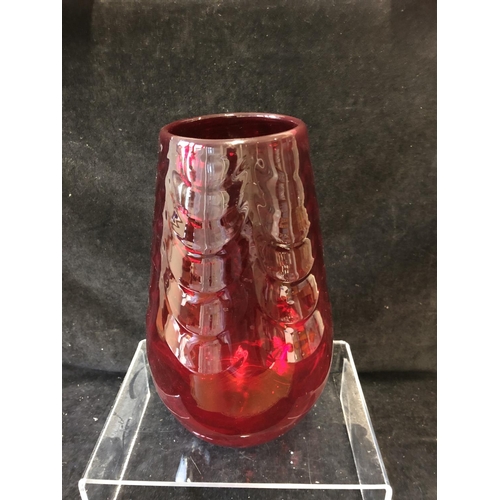 148 - A large Mid Century ruby glass vase, in the manner of Marriot Powell, Whitefriars, moulded with fest... 