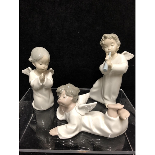 143 - Three small Lladro porcelain Angel figures: comprising: Angel laying down, No 4541; \\angel with flu... 