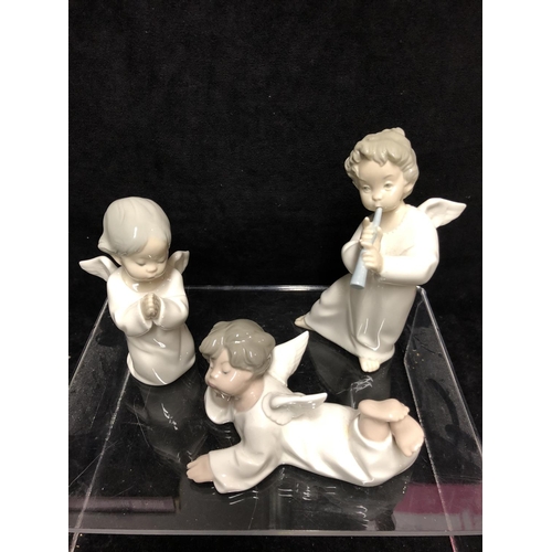 143 - Three small Lladro porcelain Angel figures: comprising: Angel laying down, No 4541; \\angel with flu... 