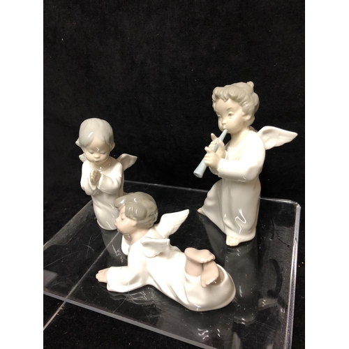 143 - Three small Lladro porcelain Angel figures: comprising: Angel laying down, No 4541; \\angel with flu... 