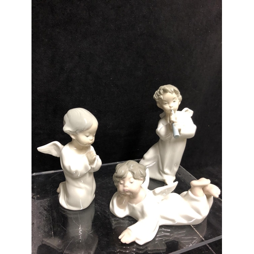 143 - Three small Lladro porcelain Angel figures: comprising: Angel laying down, No 4541; \\angel with flu... 