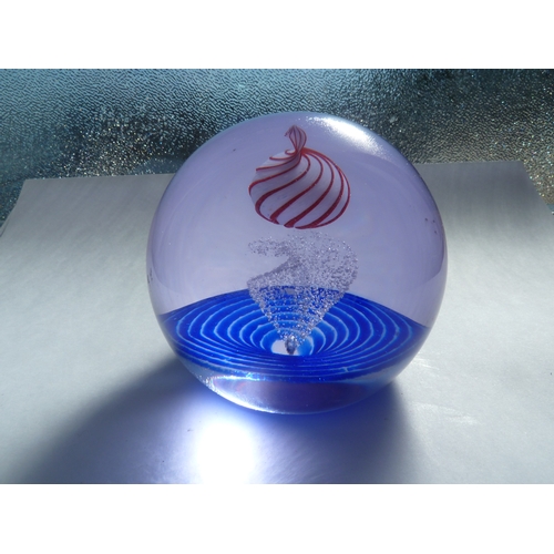 57 - Caithness - Planet Peppermint - A glass paperweight, the white planet striped in red over a granular... 