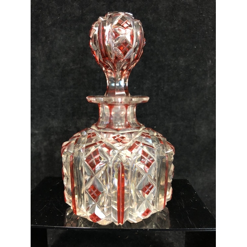 61 - Bohemian Glass - A ruby flashed colourless glass perfume bottle, of cylindrical form and octagonal s... 