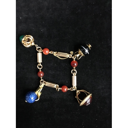 43 - An 18ct yellow gold charm bracelet in Victorian style, the bracelet formed of fluted bar links inter... 