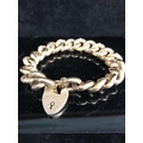 3 - An 9ct gold heavy chain link bracelet, with heart form padlock clasp, the top surface of the links e... 