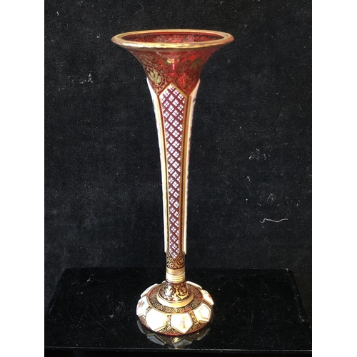 118 - A Bohemian overlay glass bud vase, the white overlay cut through to ruby with  alternate strawberry ... 