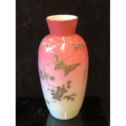 122 - A Bohemian peach blow overlay glass baluster vase, graduated deep pink over white, gilded with flowe... 