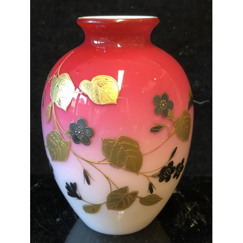 124 - A Bohemian peach blow overlay glass ovoid vase, graduated deep pink over white, gilded with a flower... 