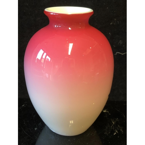 124 - A Bohemian peach blow overlay glass ovoid vase, graduated deep pink over white, gilded with a flower... 