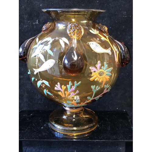 125 - A Continental glass moon vase, in the style of Moser, the deep amber coloured glass body enamelled w... 