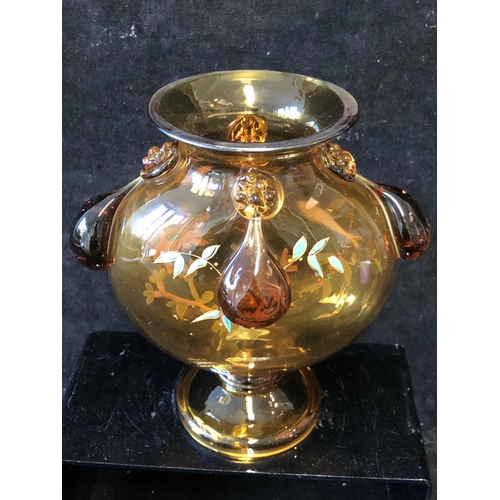 125 - A Continental glass moon vase, in the style of Moser, the deep amber coloured glass body enamelled w... 