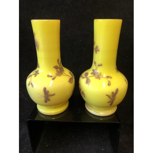 127 - A pair of Harrach overlay glass vases, of stout bottle form, yellow over shell pink, gilded with flo... 