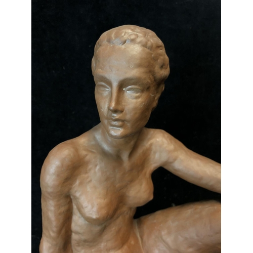 139 - An Art Deco style terracotta figure of a seated nude female, probably Austrian, impressed 12 to base... 