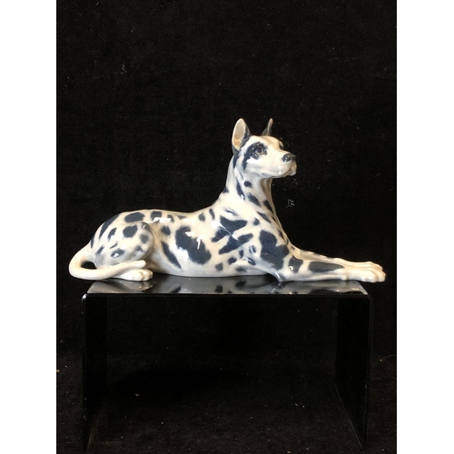 146 - Peter Herold for Royal Copenhagen Porcelain - A Great Dane dog figure, modelled reclining, grey spot... 