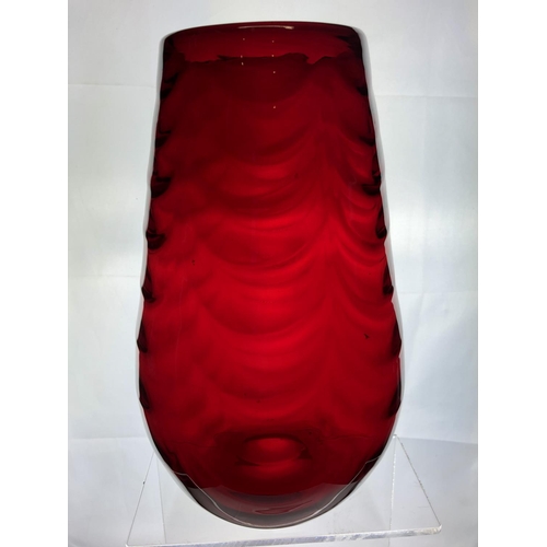 148 - A large Mid Century ruby glass vase, in the manner of Marriot Powell, Whitefriars, moulded with fest... 