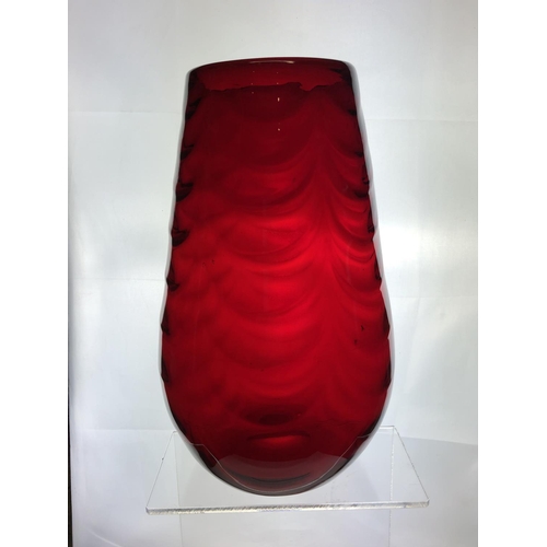 148 - A large Mid Century ruby glass vase, in the manner of Marriot Powell, Whitefriars, moulded with fest... 