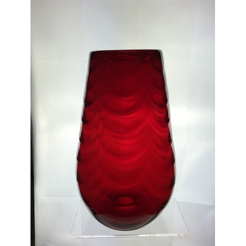 148 - A large Mid Century ruby glass vase, in the manner of Marriot Powell, Whitefriars, moulded with fest... 