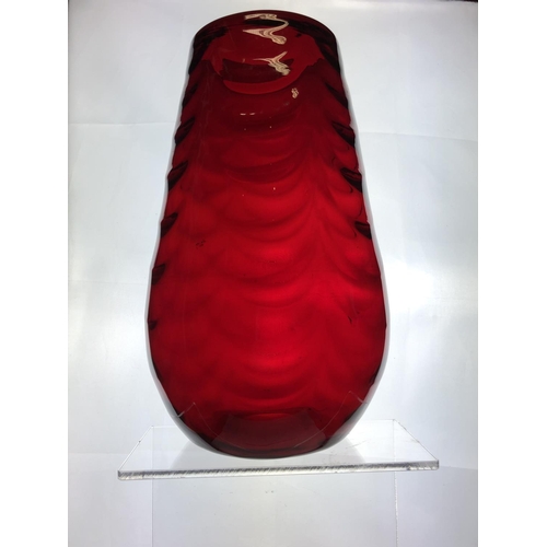 148 - A large Mid Century ruby glass vase, in the manner of Marriot Powell, Whitefriars, moulded with fest... 