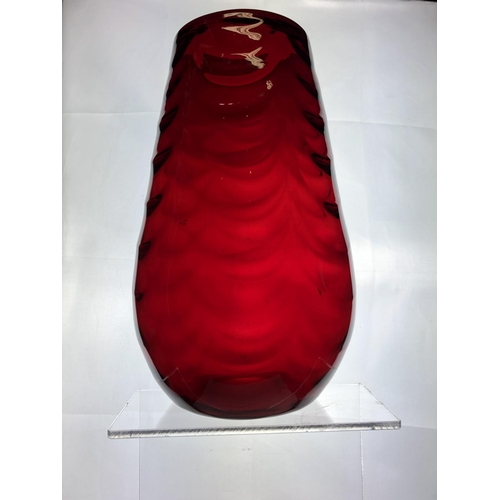 148 - A large Mid Century ruby glass vase, in the manner of Marriot Powell, Whitefriars, moulded with fest... 