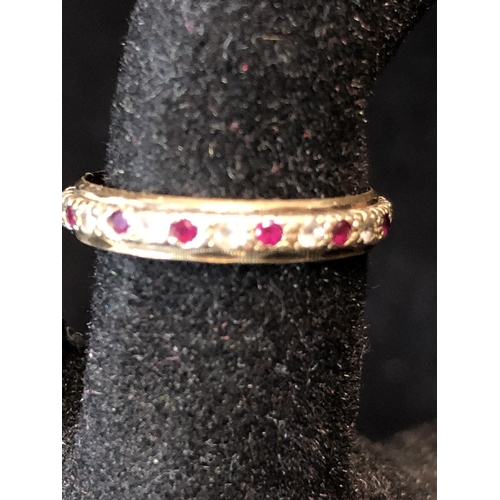 36 - A diamond and ruby full eternity ring, set in yellow and white metal, unmarked; a diamond chip illus... 