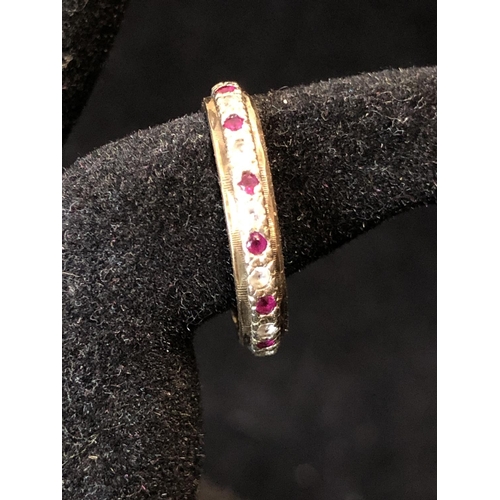 36 - A diamond and ruby full eternity ring, set in yellow and white metal, unmarked; a diamond chip illus... 