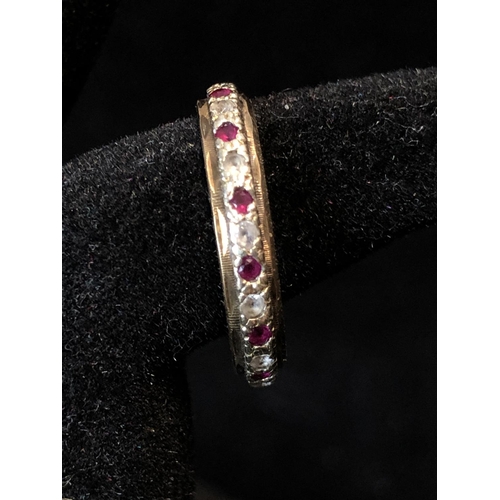 36 - A diamond and ruby full eternity ring, set in yellow and white metal, unmarked; a diamond chip illus... 