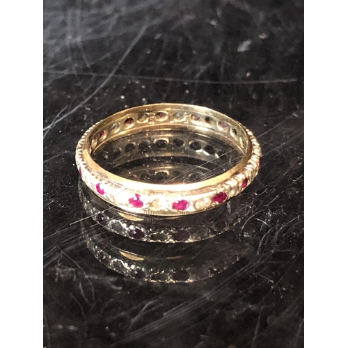 36 - A diamond and ruby full eternity ring, set in yellow and white metal, unmarked; a diamond chip illus... 