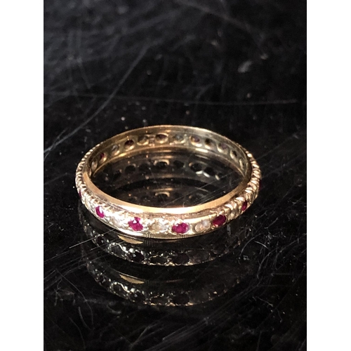 36 - A diamond and ruby full eternity ring, set in yellow and white metal, unmarked; a diamond chip illus... 