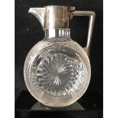 4 - A cut glass and silver plated Claret Jug, the body of circular form cut with sunbursts and strawberr... 