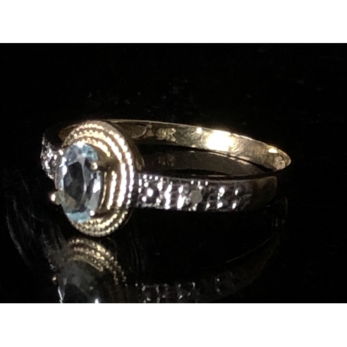 7 - Two dress rings - An oval aqua marine set in yellow gold with white metal shoulders, stamped 9K; and... 