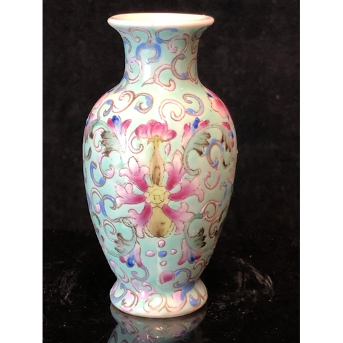 72 - A miniature Chinese famille rose porcelain baluster vase, decorated with scrolling peonies on a pale... 