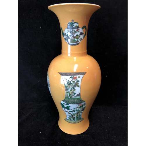 75 - A Chinese porcelain baluster vase, decorated with vases and teapots in famille verte pallete on an I... 