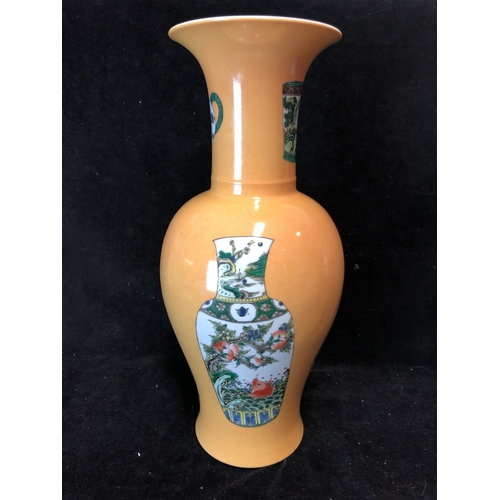 75 - A Chinese porcelain baluster vase, decorated with vases and teapots in famille verte pallete on an I... 