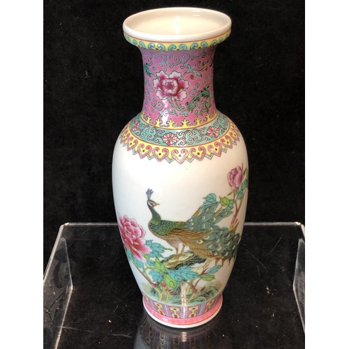 78 - A Chinese porcelain famille rose decorated baluster vase, decorated with a peacock in a peony tree, ... 