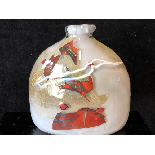 243 - Sam Herman - An elliptical arched top bottle vase, of gold grey body with iron red and white inclusi... 