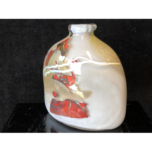 243 - Sam Herman - An elliptical arched top bottle vase, of gold grey body with iron red and white inclusi... 