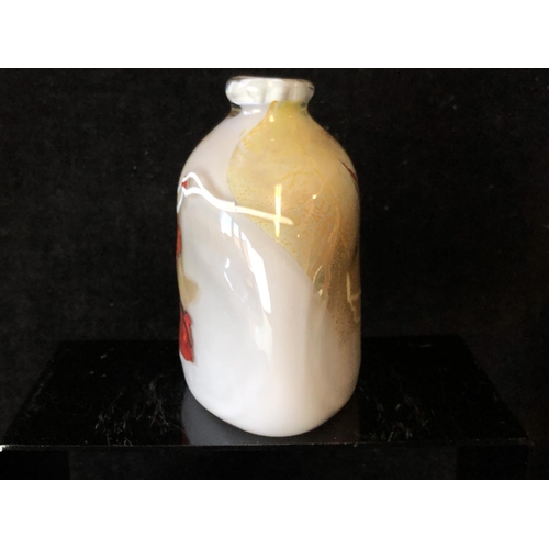 243 - Sam Herman - An elliptical arched top bottle vase, of gold grey body with iron red and white inclusi... 