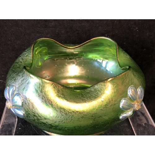 249 - A Loetz green papillon glass bowl, circular with crimped wavy upper rim, applied with iridescent blu... 