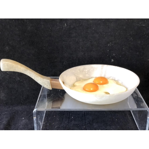 252 - Marco Ricciardi, Alabaster sculptures formed as fried eggs in av frying pan;  egg cup with cracked e... 