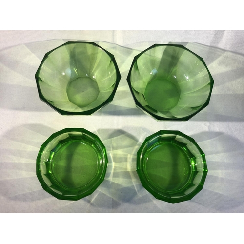 110 - Continental Glass- probably Moser, four emerald green facet cut bowls, comprising a pair of deep bow... 