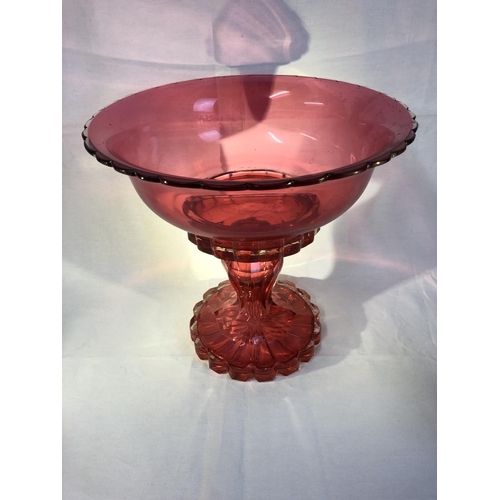 100 - Bohemian Glass - A large ruby glass centerpiece, the cased stand with hollow baluster stem, supporti... 