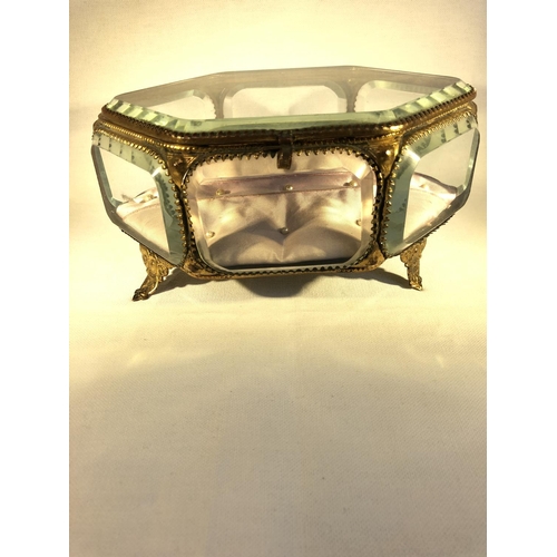 106 - French Glass - A gilt metal mounted glass jewellery box or casket, of hexagonal shape, on four volut... 