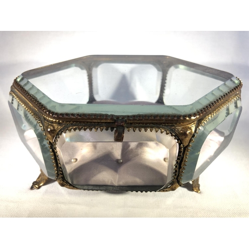 106 - French Glass - A gilt metal mounted glass jewellery box or casket, of hexagonal shape, on four volut... 