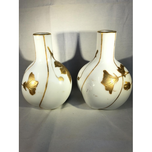 94 - Harrach,  - a pair of lobed melon form bottle vases, the white ground enamelled with sage green stri... 